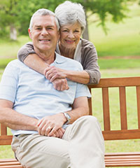 elderly couple sitting on bench